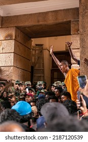 COLOMBO, SRI LANKA: 9th July 2022: Buddhist Monk In Saffron Robe Stands Over A Crowd Of Angry Protestors And Soldiers At The Presidential Secretariat.