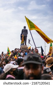 COLOMBO, SRI LANKA: 9th July 2022: Selective Focus Shot Of A Mass Street Protest With People Waving National Flags By The Presidential Secretariat HQ.