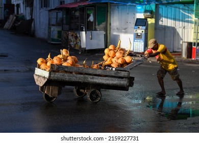 "Colombo, Sri Lanka-05.22.2022: King coconut vendor is handling his cart on the streets"