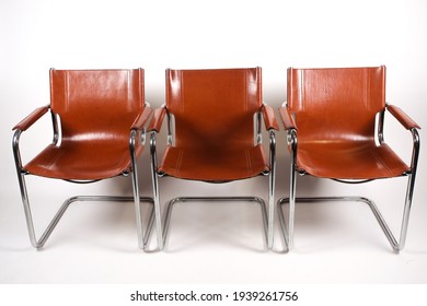 Colombo Tan Leather And Chrome Armchairs Designed By Marcel Breuer On A White Background