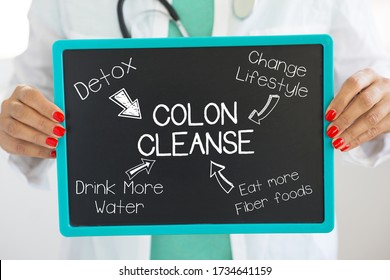 Colon cleanse concept with doctor holding a cardboard with advices how to promote a healthier lifestyle habits