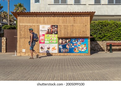 Colonia De Sant Jordi, Spain; July 02 2021: Closed Ice Cream Stand With A Tourist Walking To The Beach In The Mallorcan Town Of Colonia De Sant Jordi