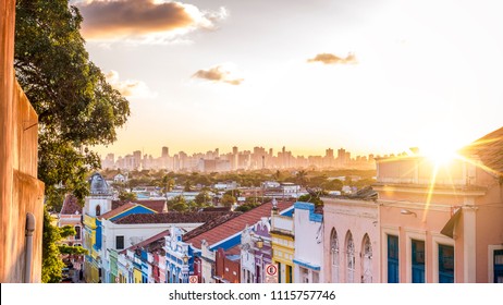The colonial buildings of Olinda contrasting with the contemporary ones of Recife in Pernambuco, Brazil at sunset.