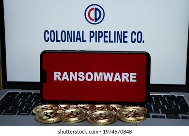 Colonial Pipeline Co Logo On The Blurred Background And Word RANSOMWARE On The Smartphone In Front. Stafford, United Kingdom, May 16, 2021.