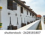 Colonial style building old windows made of wood and gabled roof