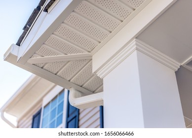 Colonial white custom porch columns with wood looking vinyl column wrap, sheets and molding, white soffit provides optimal ventilation for roof overhangs 
