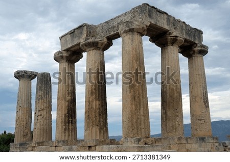 Colonnade of the Temple of Apollo under dramatic cloudy sky at sunset in Ancient Corinth. Greece