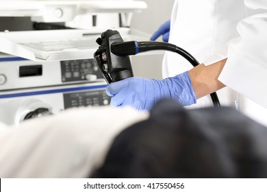 Colonoscopy. Doctor gastroenterologist with probe to perform gastroscopy and colonoscopy 