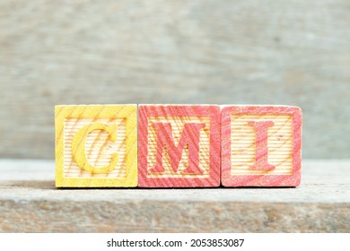 Color Alphabet Letter Block In Word CMI (Abbreviation Of Cost Management Index, Co-managed Inventory,Customer Managed Inventory Or Case Mix Index) On Wood Background