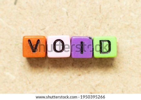 Color alphabet letter block in word void on wood background