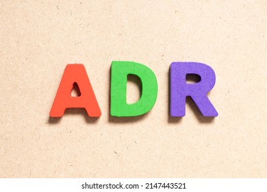 Color alphabet letter in word ADR (Abbreviation of adverse drug reaction) on wood background