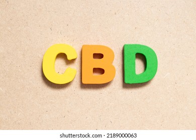 Color alphabet letter in word CBD (Abbreviation of Central business district or Cannabidiol) on wood background