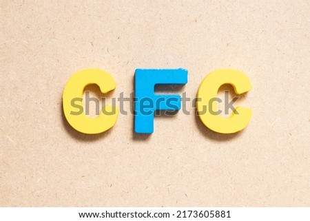 Color alphabet letter in word CFC (abbreviation of Chlorofluorocarbon) on wood background