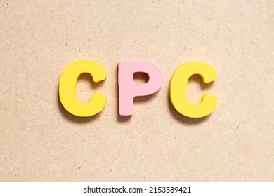 Color alphabet letter in word CPC (Abbreviation of Cost per click) on wood background