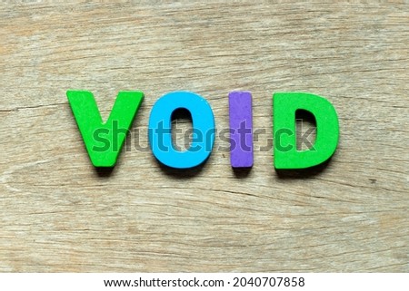 Color alphabet letter in word void on wood background