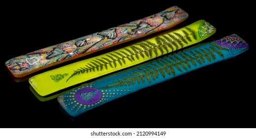 Color aromatic stick holder on dark black shiny table - Shutterstock ID 2120994149