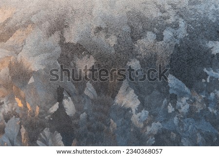 The color block pattern formed by the ice flowers on the glass under the illumination of morning light