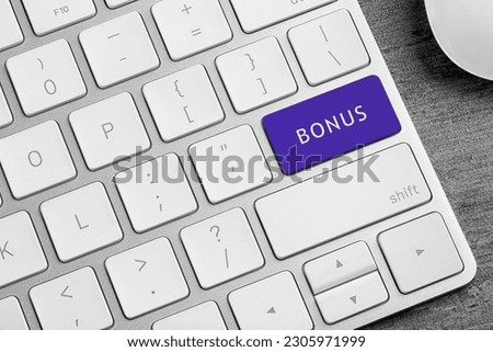 Color button with word Bonus on computer keyboard, top view