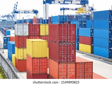 Color Cargo Containers With Loading Cranes In Storage Warehouse