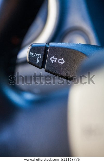 Color\
close up footage of a car\'s turn signal\
lever.