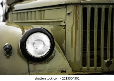 Color Close Up Of A Green Vintage Car Headlight And Turn Signal.