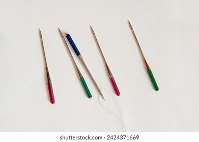 Color Coded Sewing Machine Needles. Color Coded Sewing Machine Needles, Focus on Eye of Needle Points, aim, point, focus, skill, technical, accuracy, engineering, precision, closeup, color coded