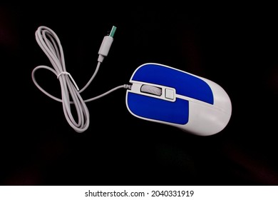 Color Computer mouse with USB cable, isolated on a black background, click the mouse, scroll wheel, wired.