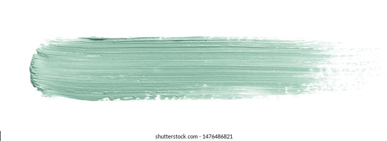 Color corrector stroke isolated on white background. Green color correcting concealer cream smudge smear swatch sample. Makeup base creamy texture