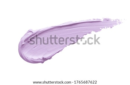 Color cream swatch smear smudge isolated on white background. Light purple lilac color correcting concealer stroke. Thick creamy makeup texture