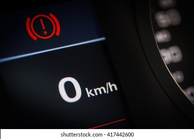 Color detail of a warning symbol in a car.