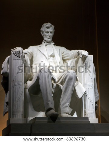 Color DSLR picture of the Statue of Abraham Lincoln at the Lincoln Memorial, at night.  The symbol is a popular tourist destination, though no people are seen.  Vertical with copy space for text.