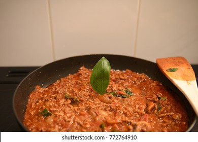 Color Food Photography Image Of The Preparation Of A Home Made Lasagna Family Meal With The Mince Meat Onion And Sauce With All Ingredients In A Pan With Fresh Basil Leaf And Wooden Spoon 