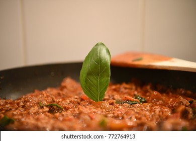 Color Food Photography Image Of The Preparation Of A Home Made Lasagna Family Meal With The Mince Meat Onion And Sauce With All Ingredients In A Pan With Fresh Basil Leaf And Wooden Spoon 