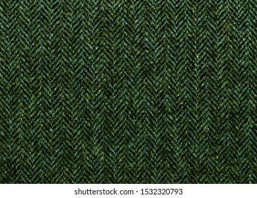 Color Of The Grass. Dark Green Herringbone Tweed, Wool Background Texture. Expensive Men's Suit Fabric. Virgin Wool Extra-fine. High Resolution