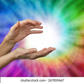 Color healing therapist sensing color energies - Female hands cupped in energy sensing position with a rainbow vortex behind and a ball of white energy in the center