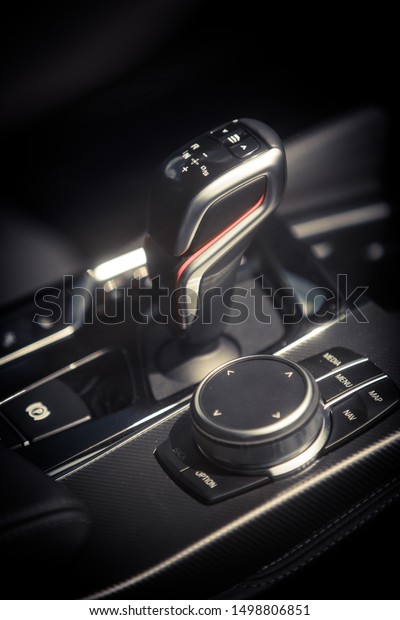 Color image of an automatic transmission gear\
shifter of a car.