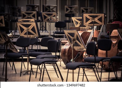 Color Image Of Some Orchestra Empty Seats On A Stage.