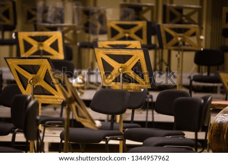 Color image of some orchestra empty seats on a stage.