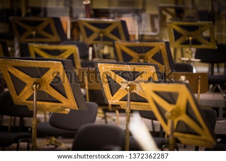 Color image of some orchestra empty seats on a stage.