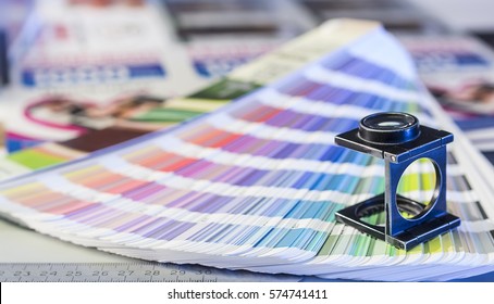 Color management in printing process with magnifying glass and color swatches