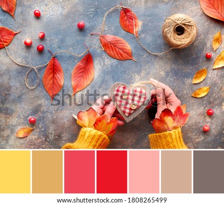 Color matching palette from image of woman hands holding wooden heart. Color palette includes honey dijon shade. Top view of table with Fall handmade decorations from natural materials.