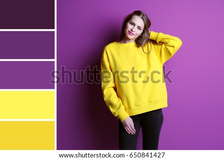 Color matching palette. Young woman posing on lilac background