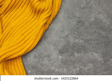 color mustard woolen winter scarf isolated on wooden background