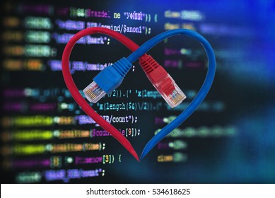Color network cables  in form of human heart and software computer programming code.  Data Network Hardware Concept.