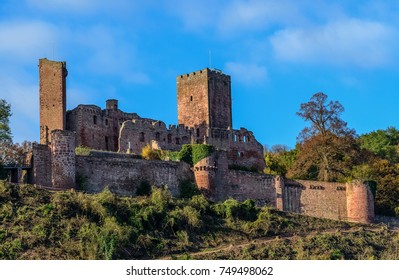 Color outdoor image of the ruin of the medieval castle / fortress Henneburg, Wertheim, Germany, on a sunny bright day in autumn / fall with blue sky and light clouds