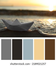 Color palette appropriate to photo of white paper boat on beach near sea at sunset - Shutterstock ID 2189021257