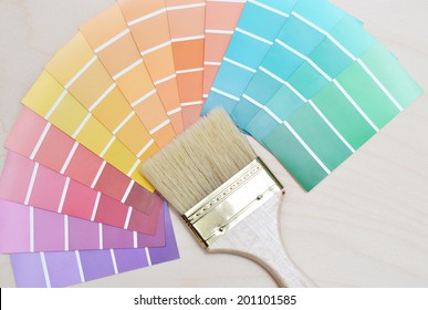 color palette and brush on a wooden background.