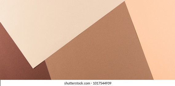 Color papers geometry composition banner background with pink, beige and brown tones.