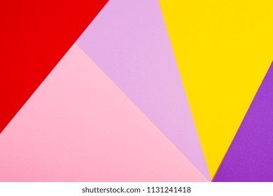 Color papers geometry flat composition background with violet, purple, pink, red, yellow tones.