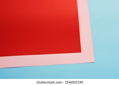 Color papers geometry flat composition background with red pink and blue tones